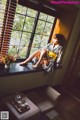 A woman in a kimono sitting on a window sill.